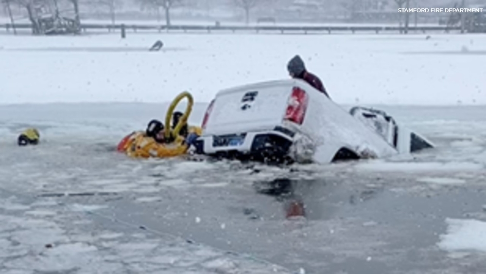2 rescued from sinking truck in icy water during storm