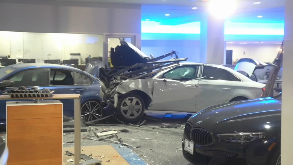 Car causes major damage after crashing into BMW dealership