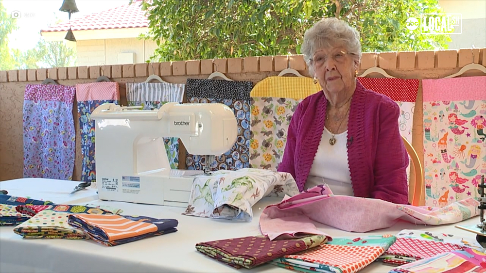 Woman sews pillowcases for children in hospitals