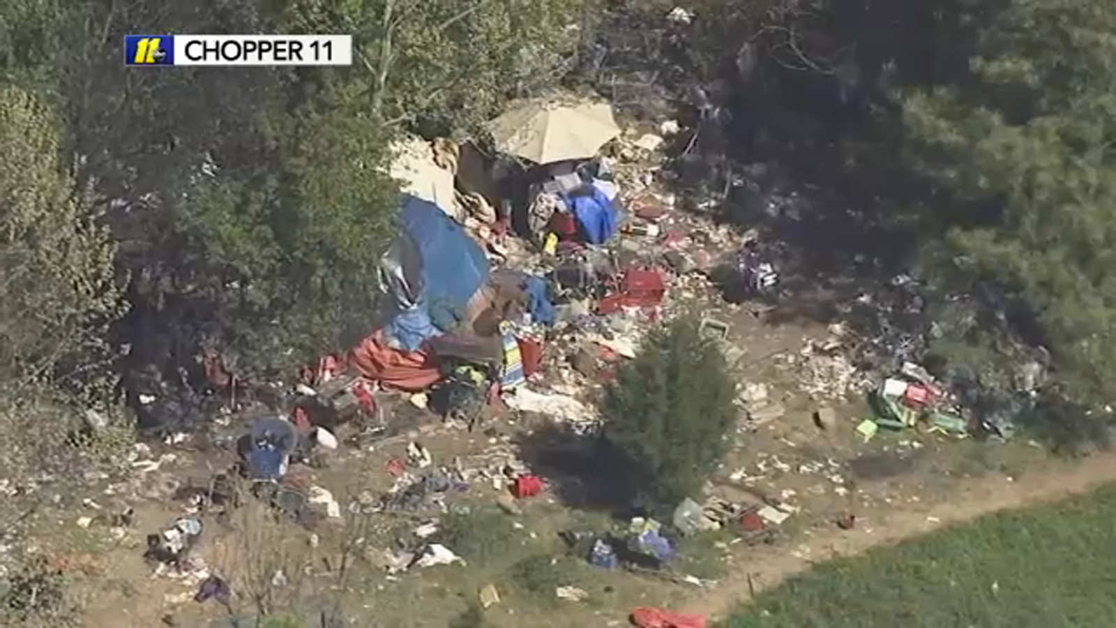 Trash buildup at homeless camp near I-540 results in calls for cleanup ...