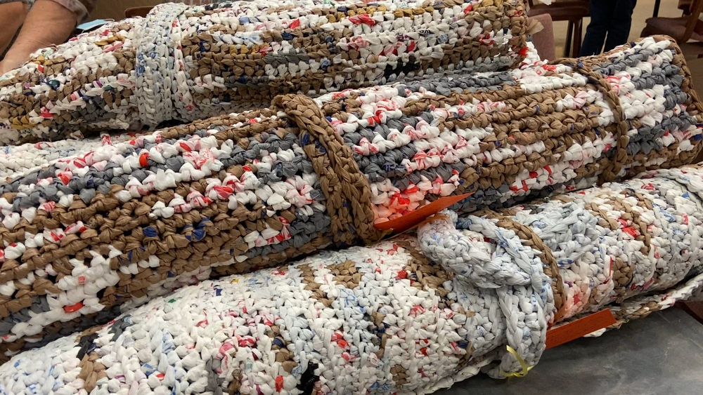 Church members create mats for homeless with grocery bags