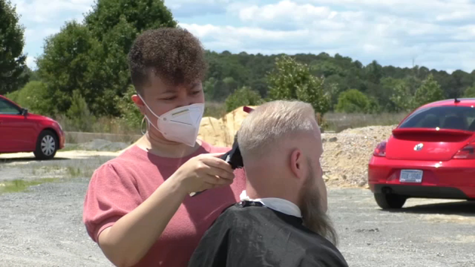 Group gives free food, haircuts, clothing to homeless camp near I-540