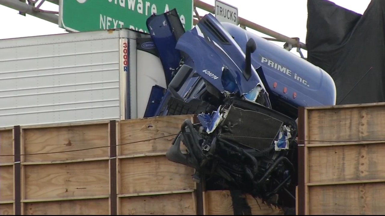 Tractor-trailer dangles over side of highway after crash on I-95