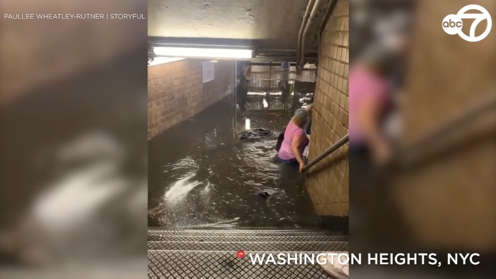 Straphangers wade through flooded NYC subway station
