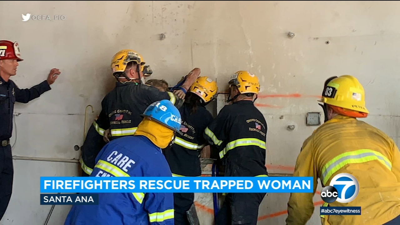 Woman rescued after getting trapped between buildings in OC
