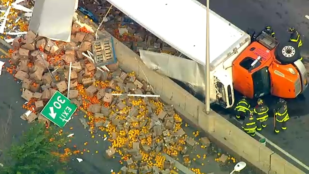 Truck hauling vegetables overturns on BQE