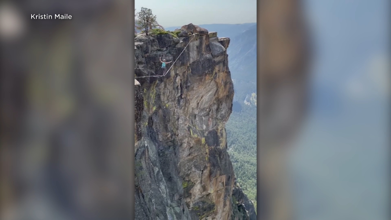 Highliners walk side of Taft Point in Yosemite National Park: VIDEO