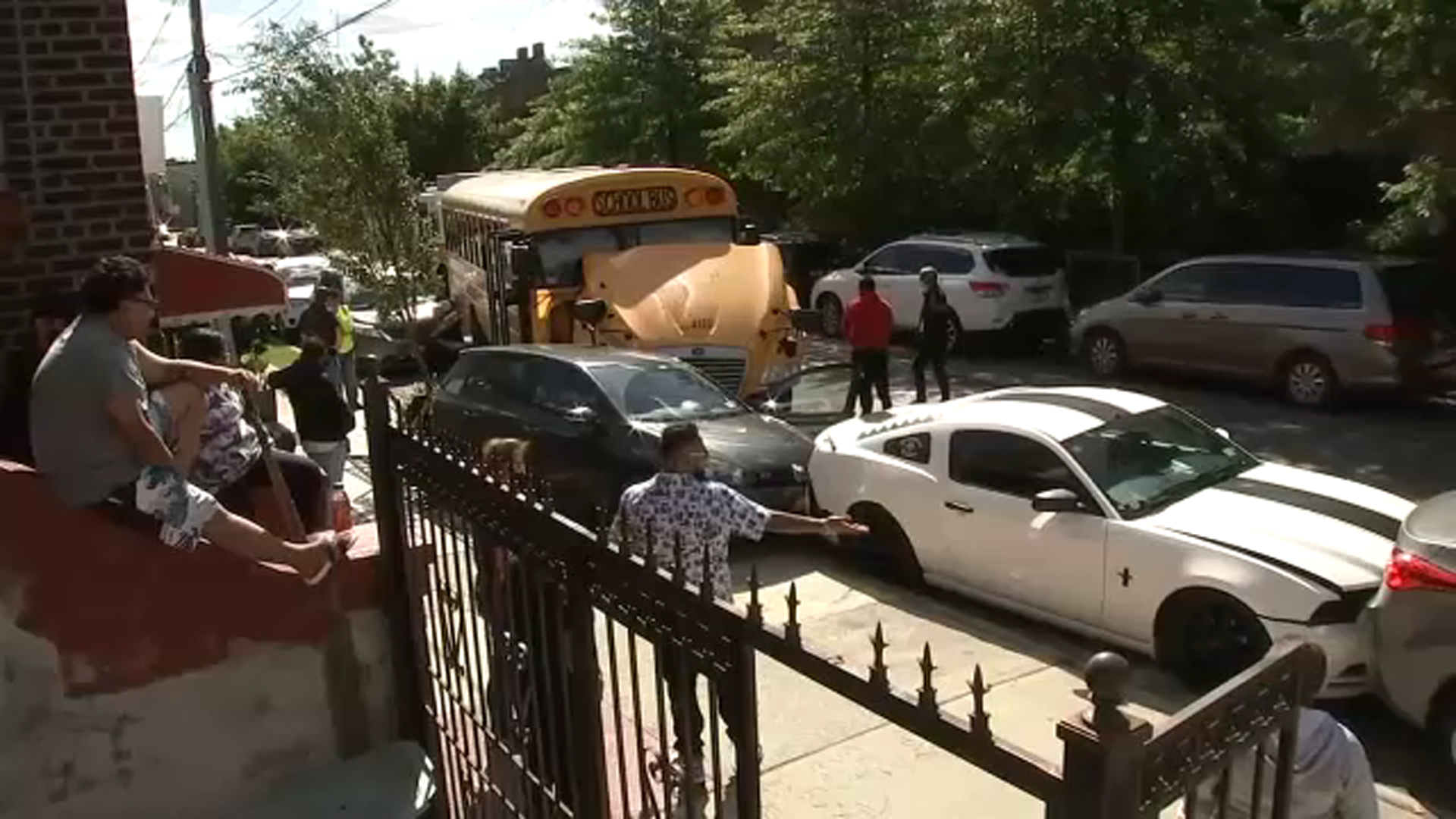 Witnesses say 2 teens crash school bus into parked cars in NYC