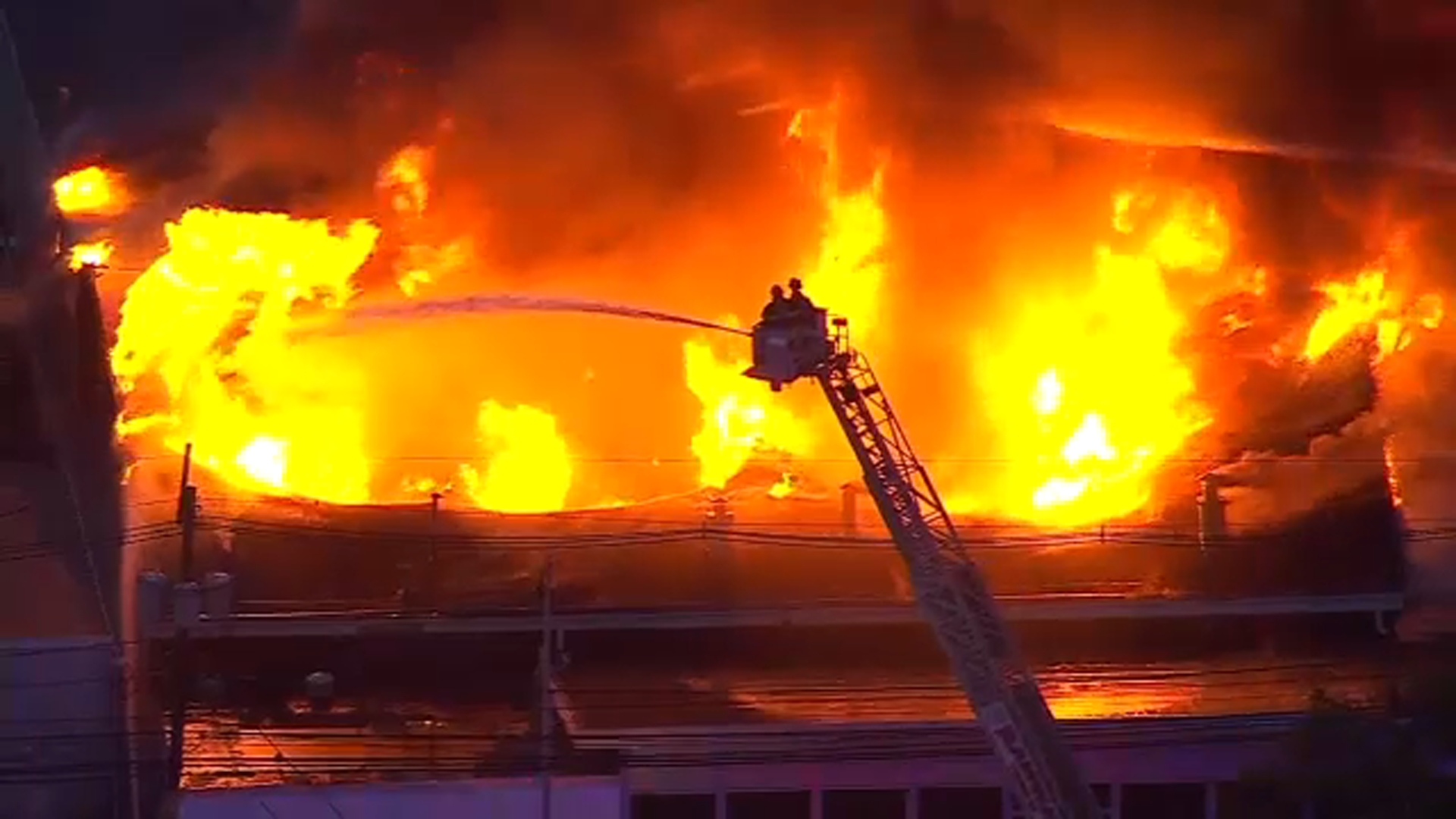 Multi-alarm fire burning at former auto dealership in NJ