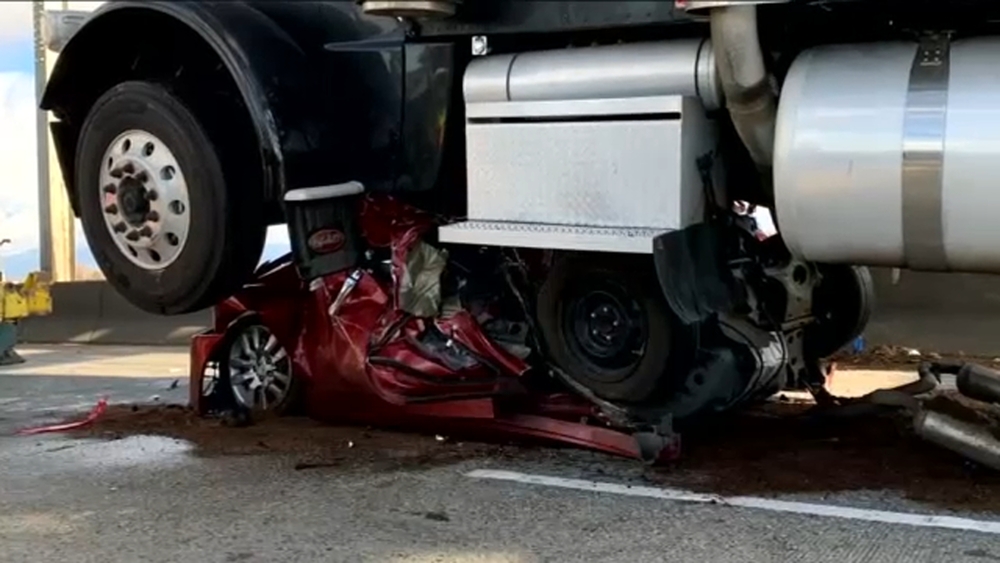 Woman survives car being flattened by semi