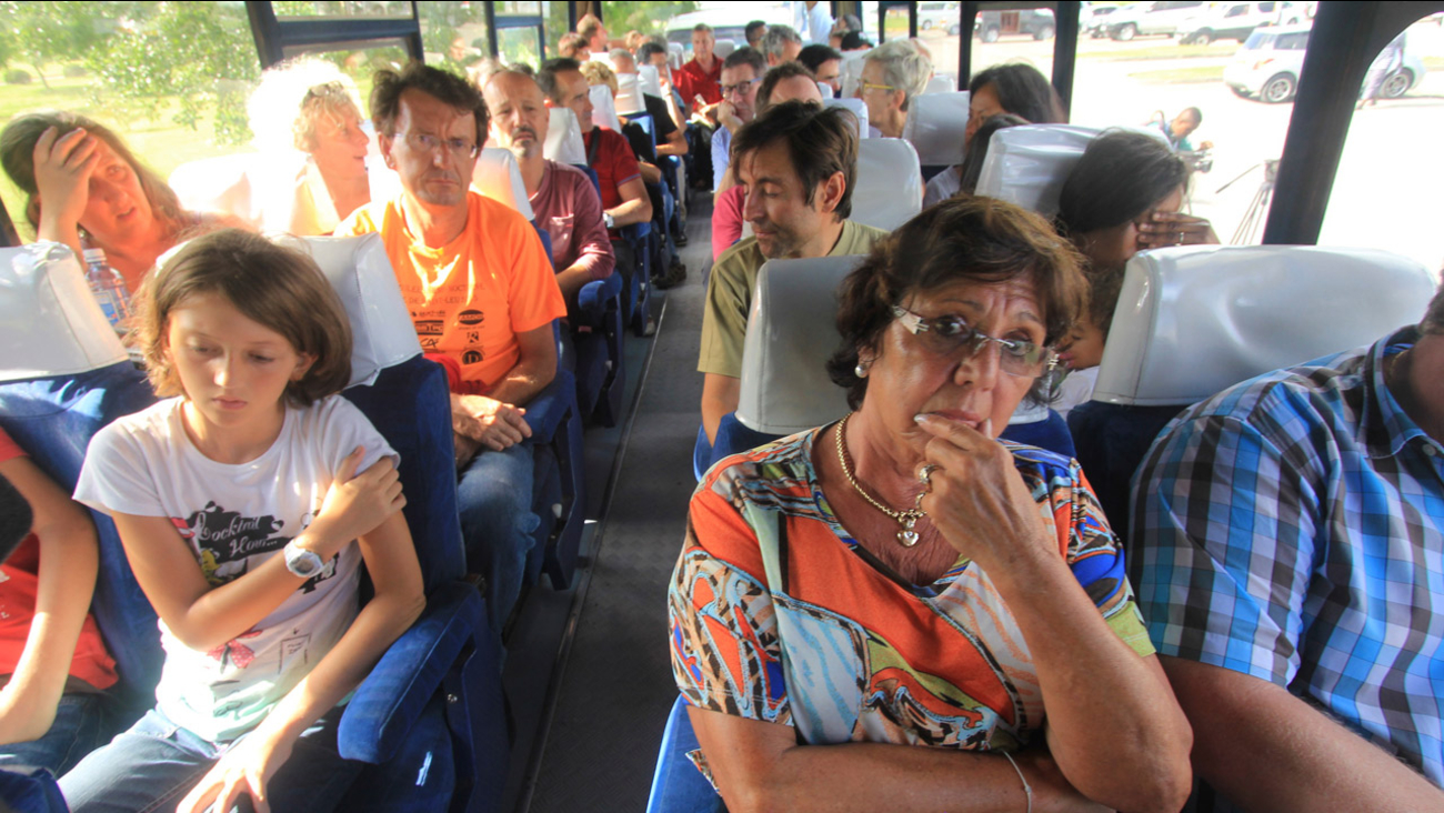 Passengers of an Air France plane which made an emergency landing at Moi International Airport ride on a bus after being evacuated from the plane in Mombasa on Dec. 20, 2015.