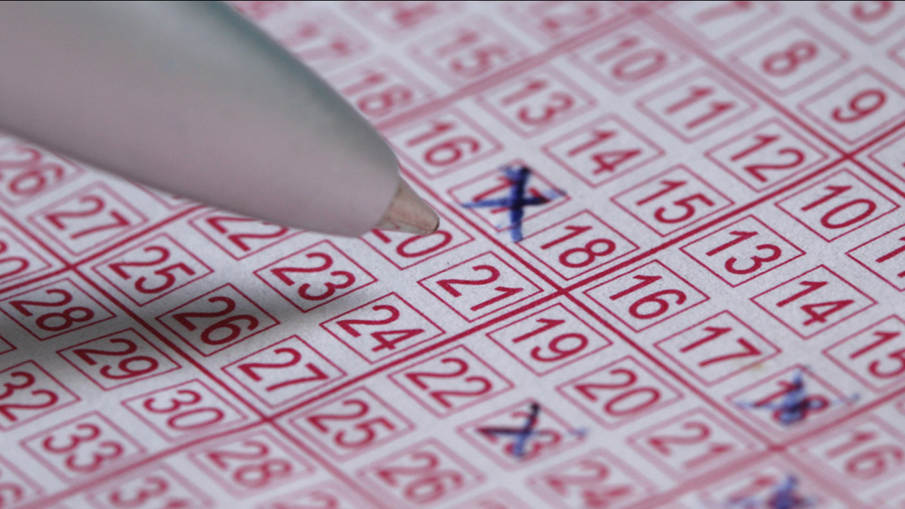A lotto ticket with numbers crossed out by a pen is shown in an undated file photo.