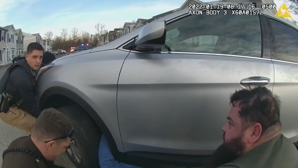 Police officers, good Samaritan lift SUV off trapped woman