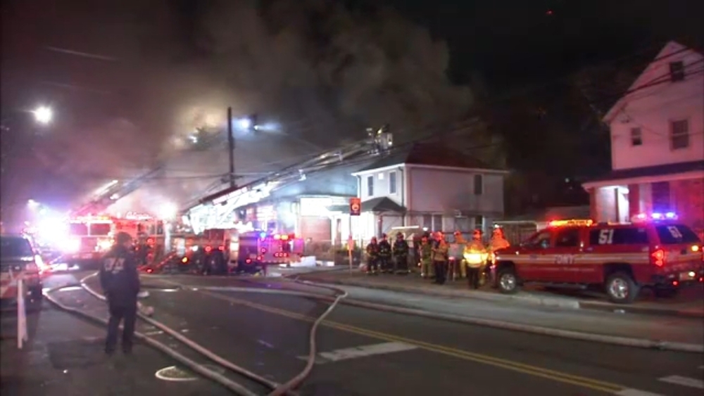 Firefighters battle massive warehouse fire in Queens