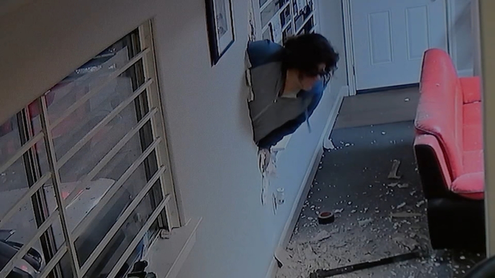 Video shows thief break through dry wall at car shop in SE Houston