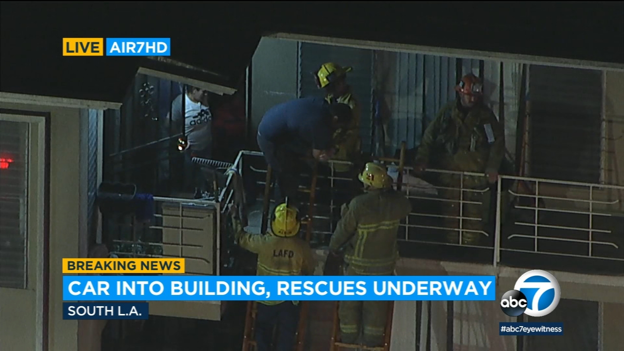 Several children rescued after car crashes into South LA apartments