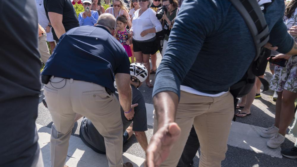 Biden takes spill while getting off bike after beach ride