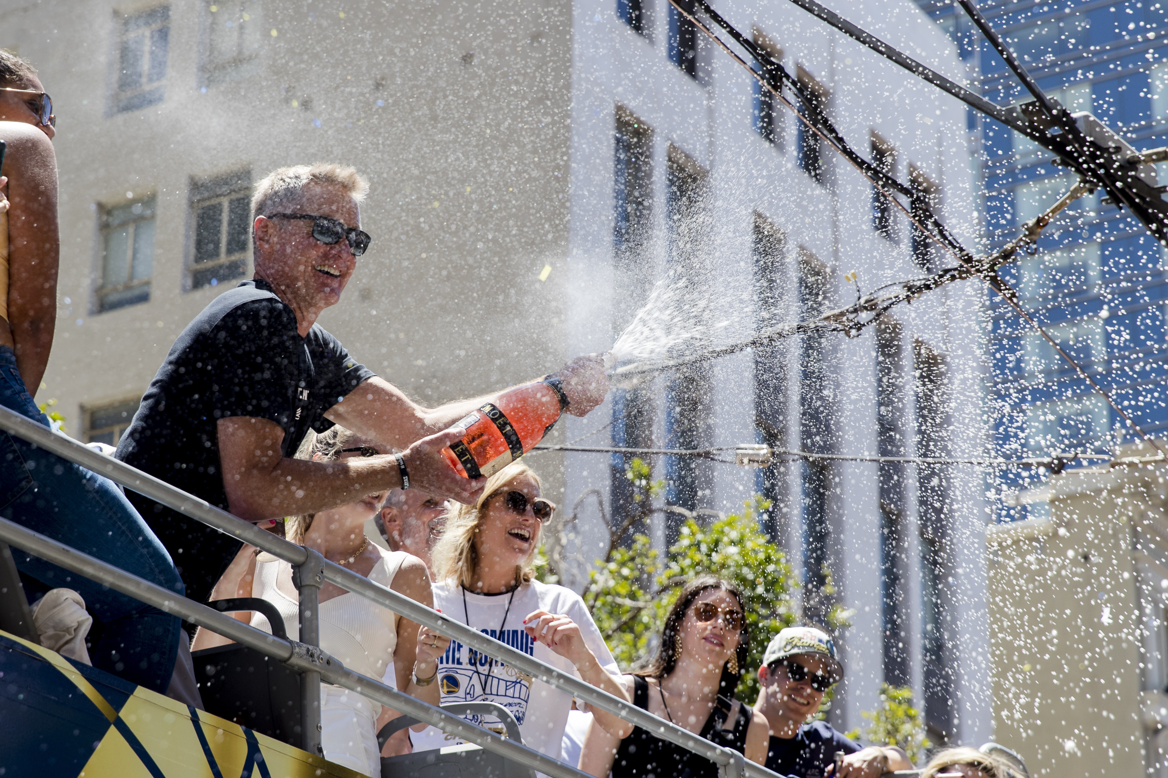 Golden State Warriors head coach Steve Kerr sprays champagne on the crowd during the NBA Championship parade in San Francisco, Monday, June 20, 2022, in San Francisco.