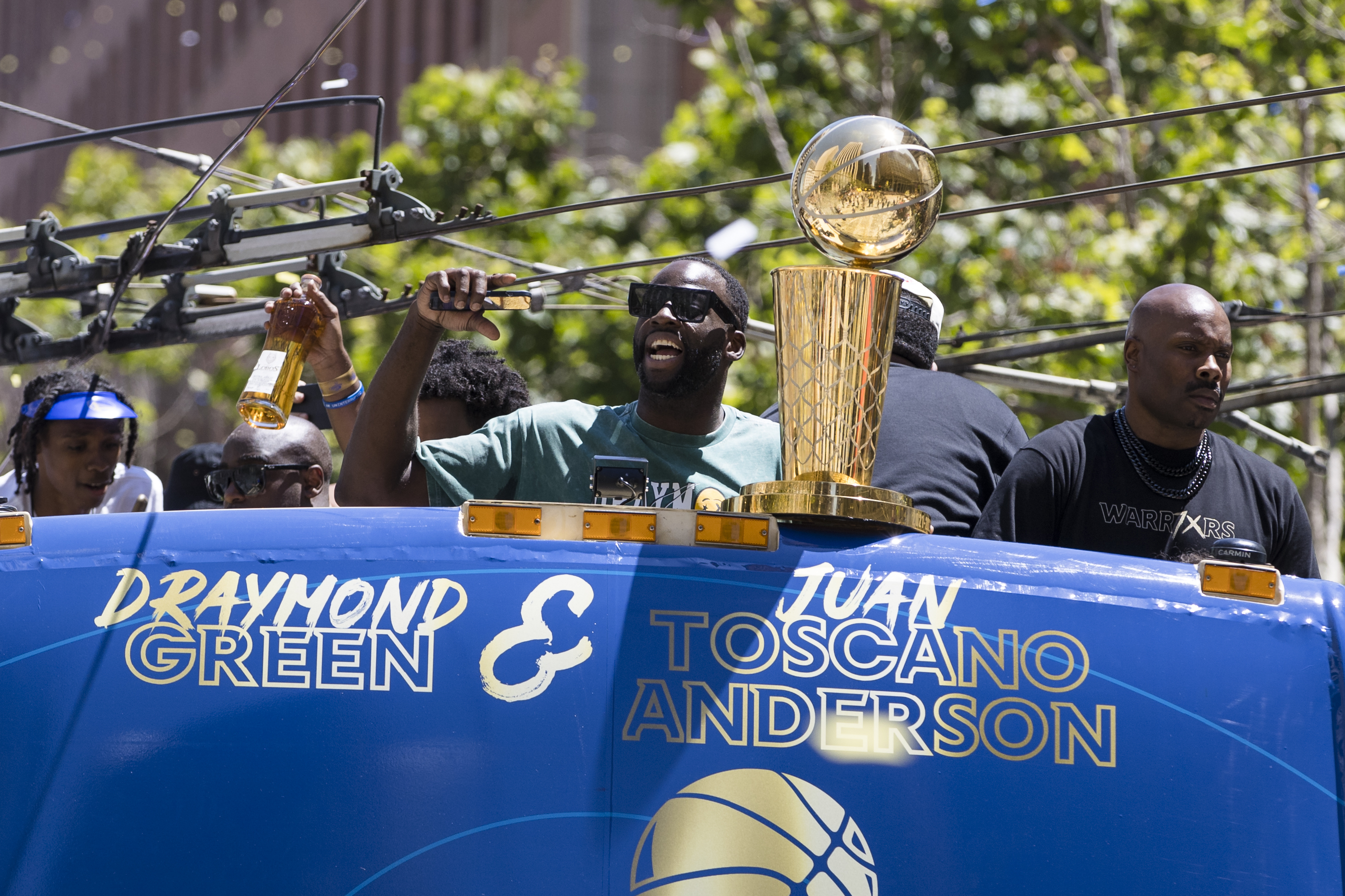 Golden State Warriors' Draymond Green holds the Larry O'Brien trophy during the NBA Championship parade in San Francisco, Monday, June 20, 2022, in San Francisco.