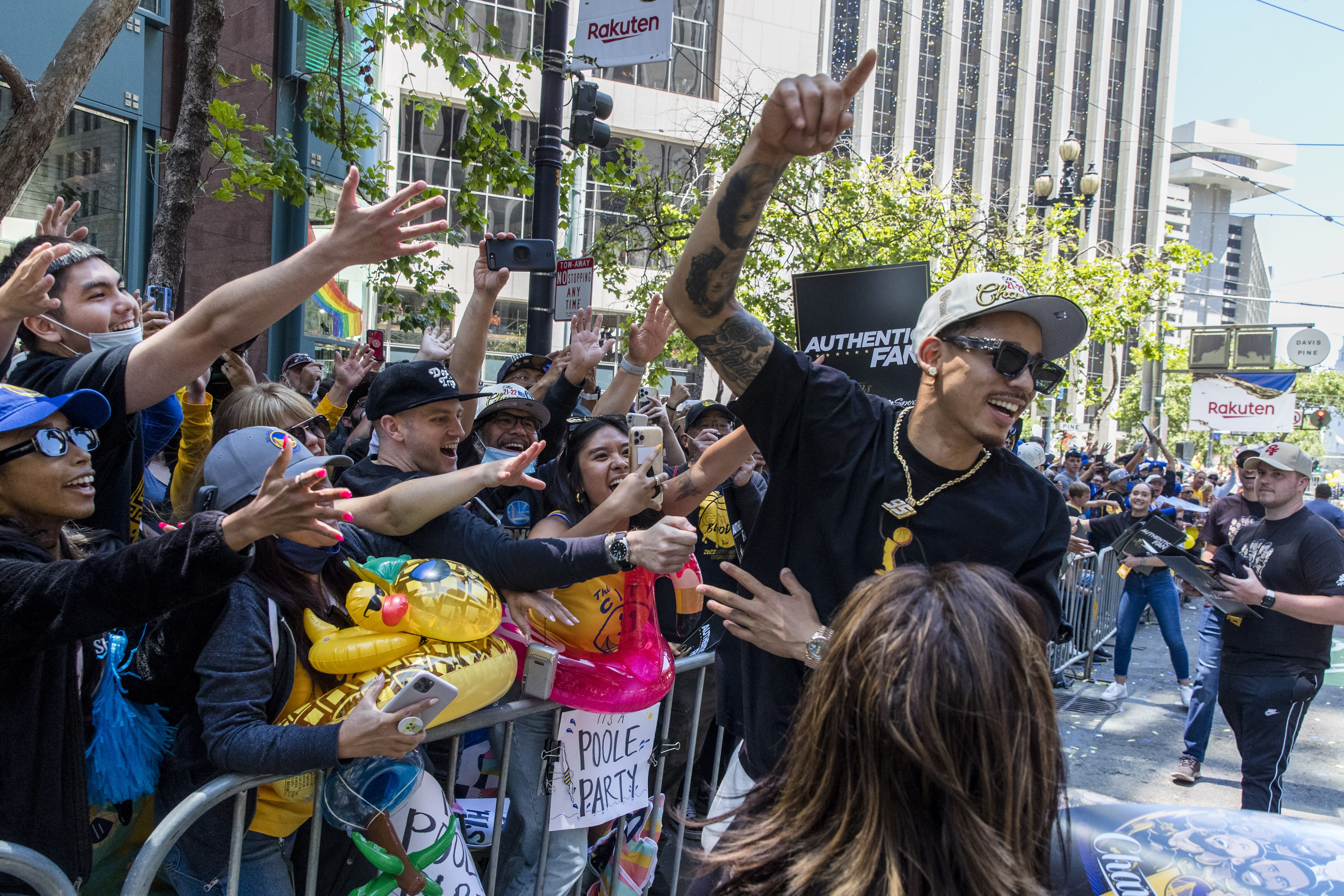 Golden State Warriors' Juan Toscano-Anderson celebrates with fans during the NBA Championship parade in San Francisco, Monday, June 20, 2022, in San Francisco.