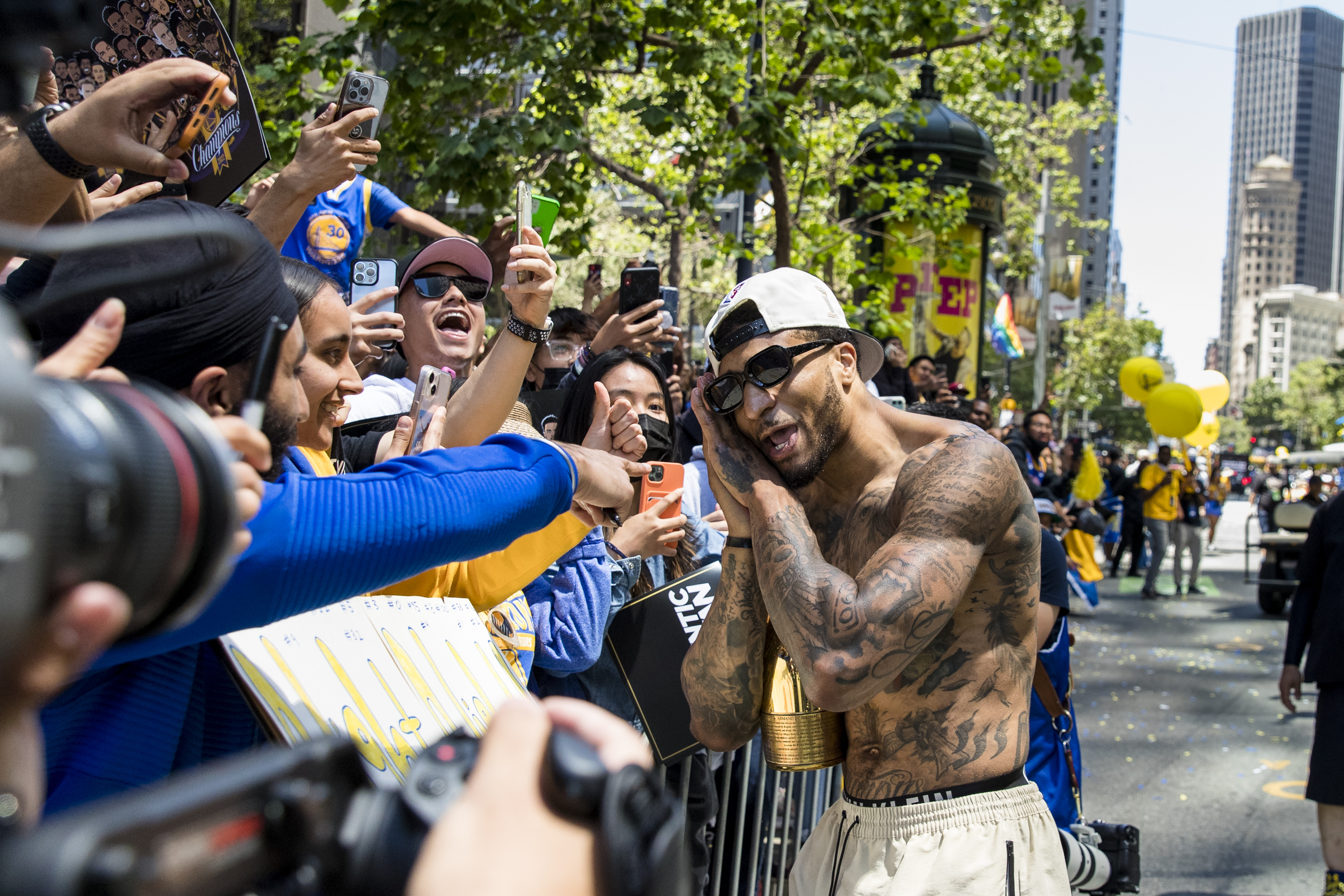 Golden State Warriors' Gary Payton II celebrates with fans during the NBA Championship parade in San Francisco, Monday, June 20, 2022, in San Francisco.