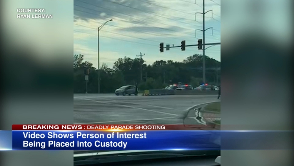 Video: Person of interest in parade shooting placed into custody after chase