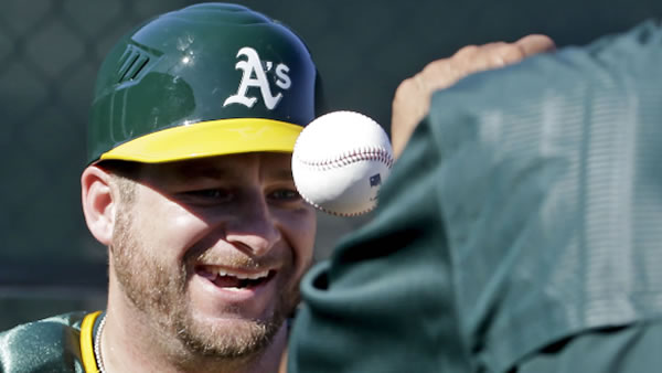 Oakland Athletics catcher Stephen Vogt works on a drill during spring training baseball practice in Mesa, Ariz., Sunday, Feb. 21, 2016.