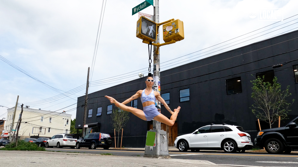 Aerialist performs while hanging from her hair