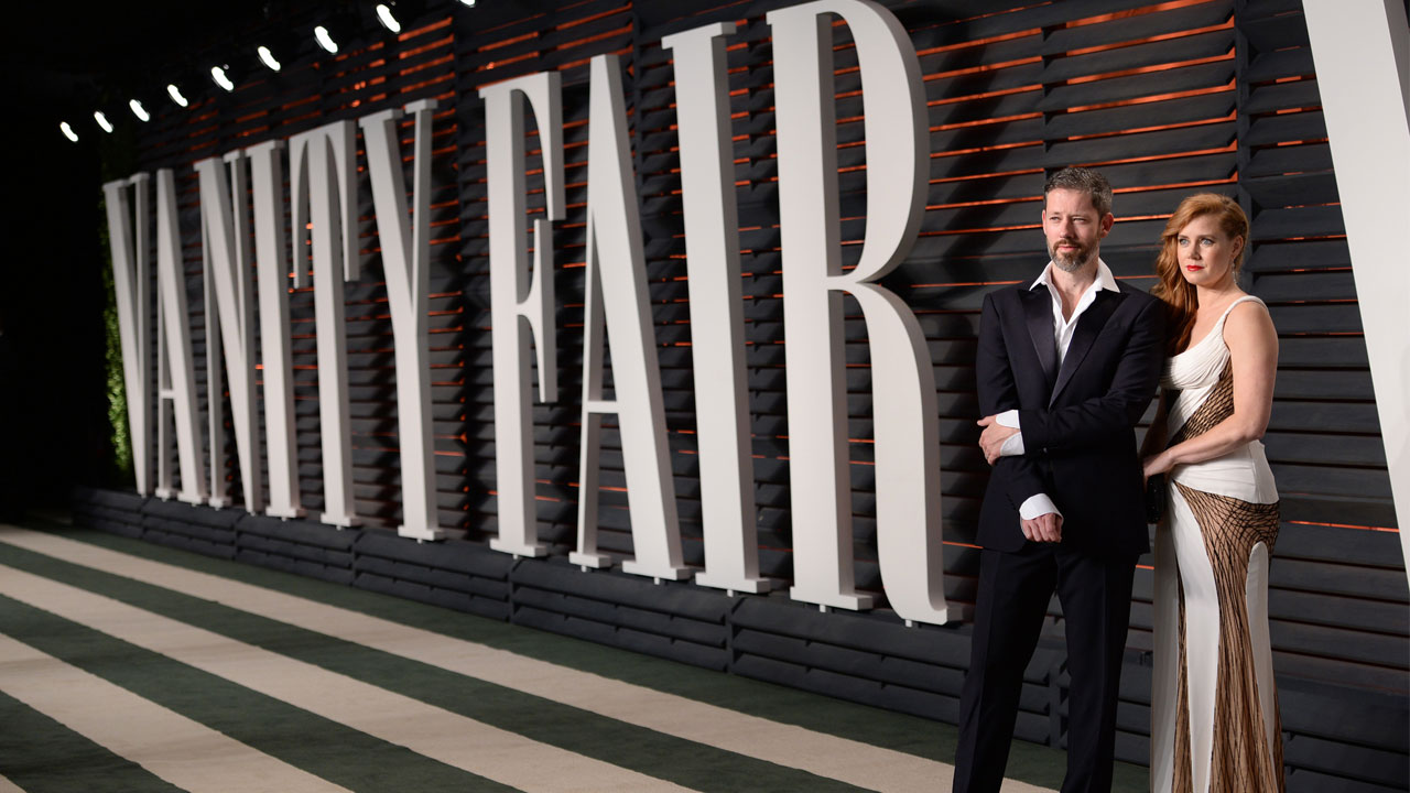 Darren Le Gallo, left, and Amy Adams arrive at the Vanity Fair Oscar Party on Sunday, Feb. 28, 2016, in Beverly Hills, Calif.