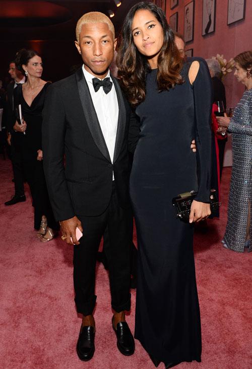 Pharrell Williams, left, and Helen Lasichanh attend the Governors Ball after the Oscars on Sunday, Feb. 28, 2016, at the Dolby Theatre in Los Angeles.