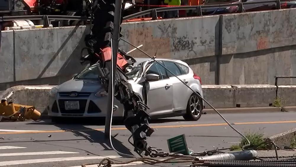 Crane boom falls onto car in NY; woman miraculously survives