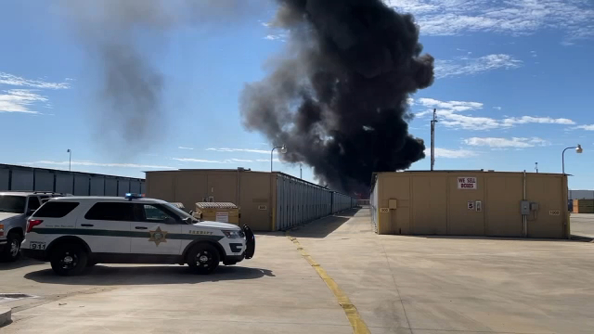 Debris fire breaks out near storage facility in Fresno