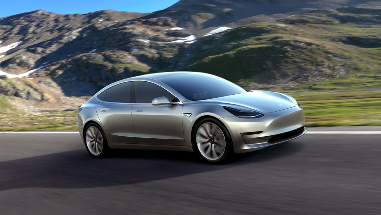 This undated photo provided by Tesla Motors shows the Model 3 car. The promise of an affordable electric car from Tesla Motors had hundreds of people lining up to reserve one.
