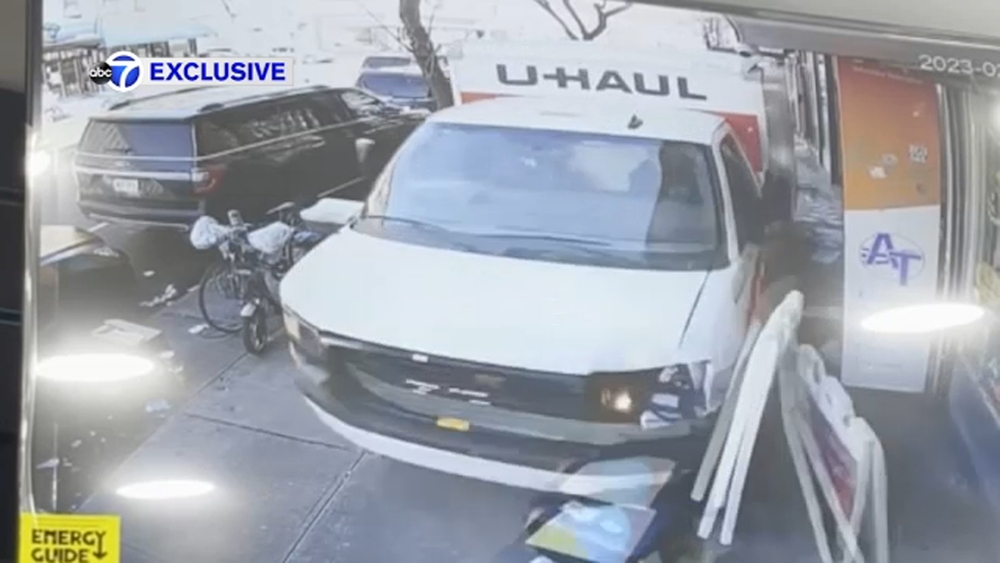Exclusive: U-Haul truck jumps curb, barrels down sidewalk