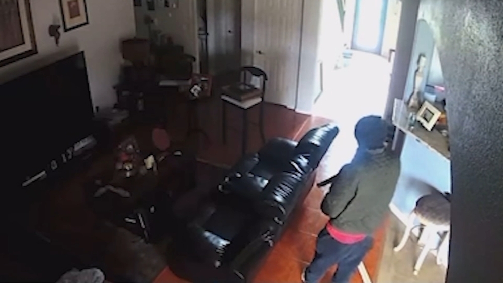Video shows burglar kick door down before retired cop confronts him