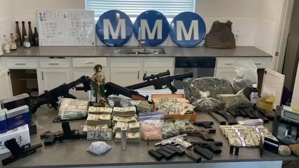 Guns, drugs and Louisiana murder suspect found in Houston home raid