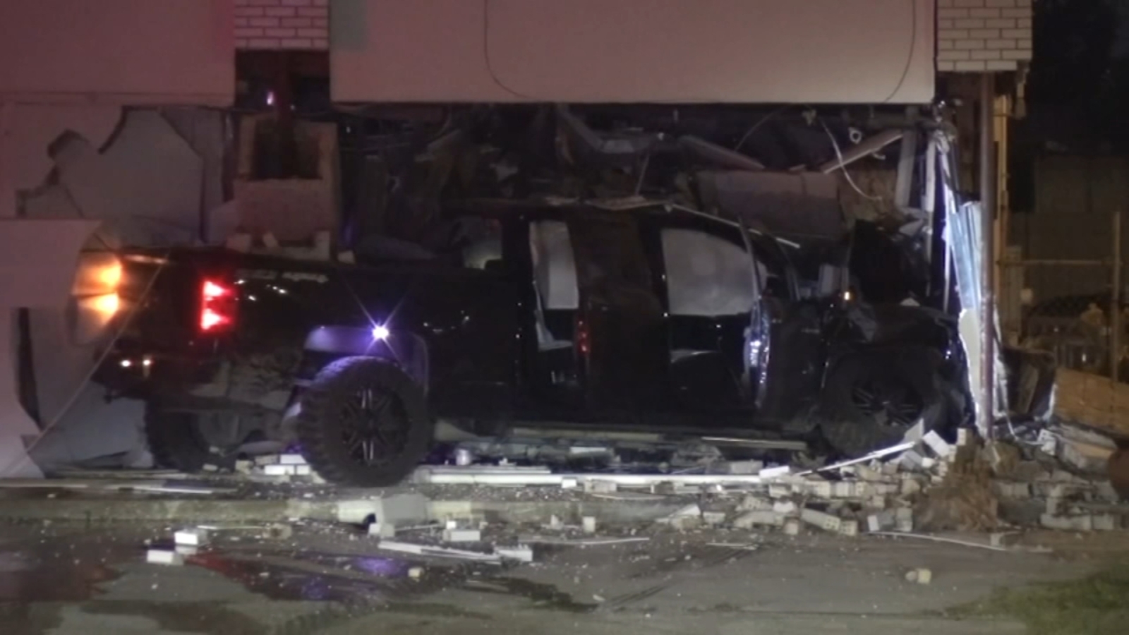 Driver crashes into building during police chase barely missing oncoming train HPD says