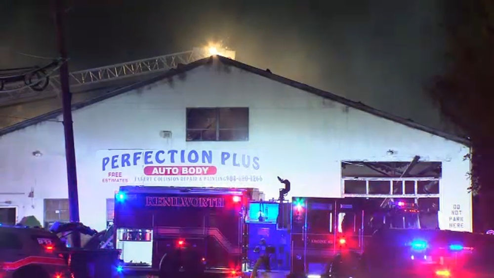 Fire burns through auto body shop in NJ