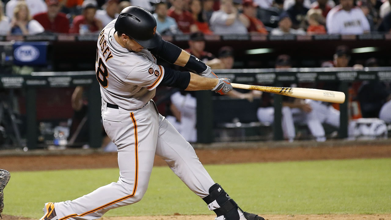 San Francisco Giants' Buster Posey connects for a two-run double against the Arizona Diamondbacks during the ninth inning of a baseball game Saturday, May 14, 2016, in Phoenix.