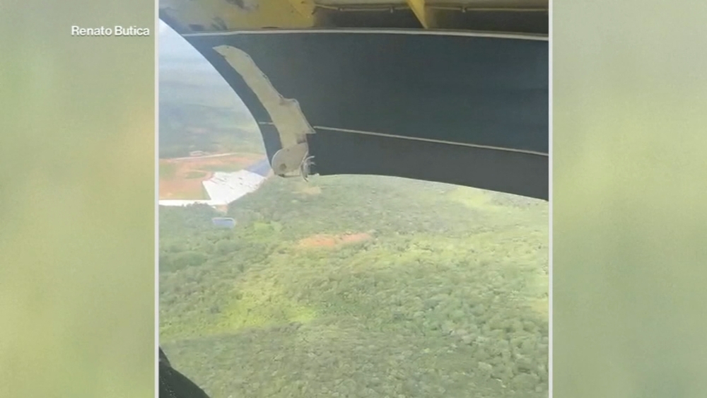 Plane makes emergency landing after door bursts open during flight
