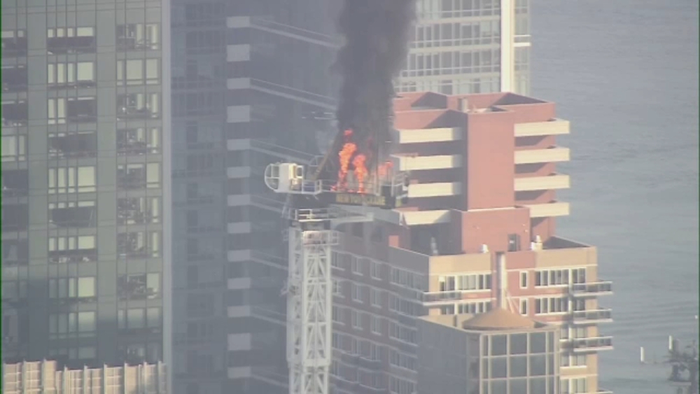 Crane catches fire, partially collapses on top of Midtown high-rise