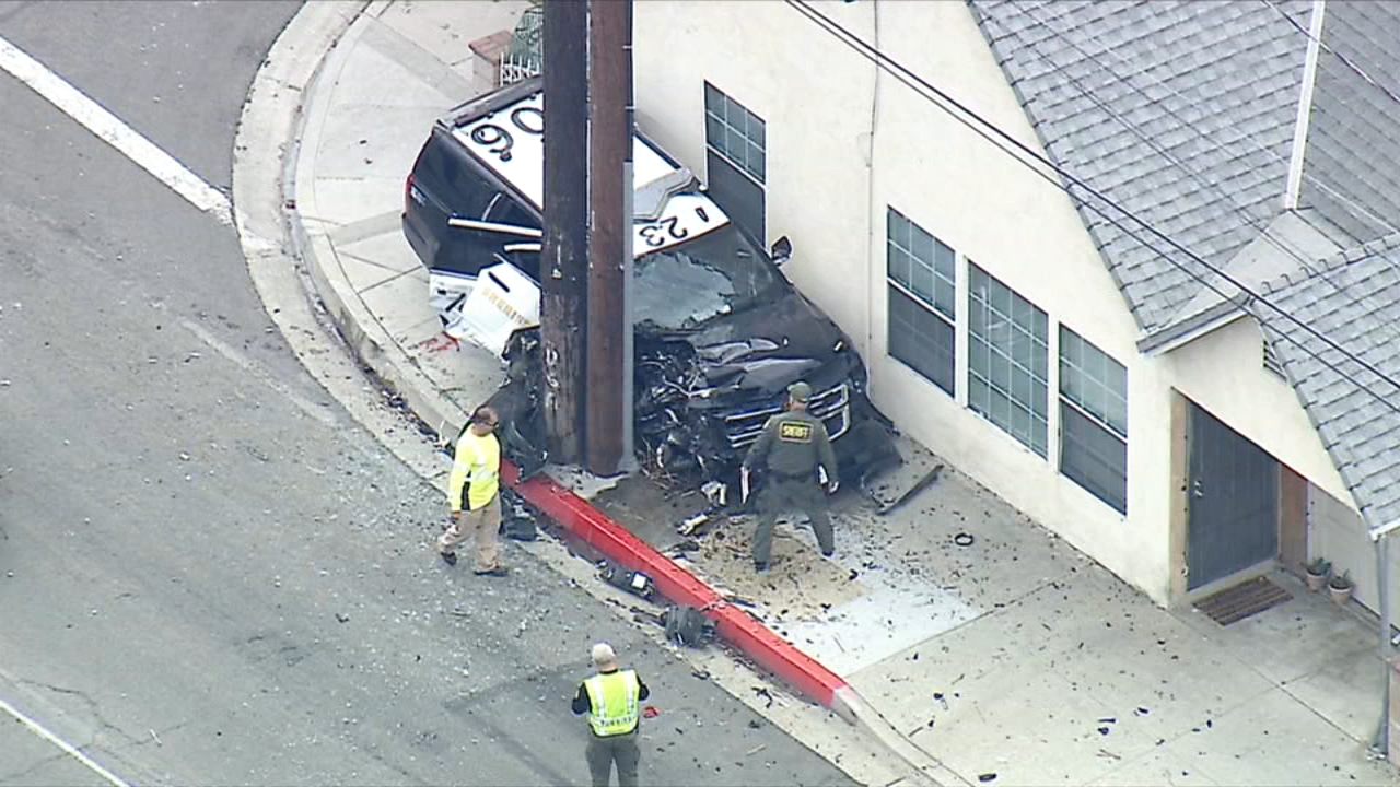 LASD vehicle ends up wedged between power pole and house after crash