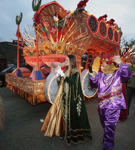 Actress Hillary Swank walks to her float in the staging area before the start of the Mardi Gras parade in New Orleans, Monday, Feb. 20, 2012.