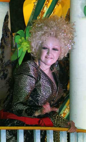 Entertainer Cyndi Lauper throws beads while riding in the Mardi Gras parade in New Orleans, Monday, Feb. 20, 2012.