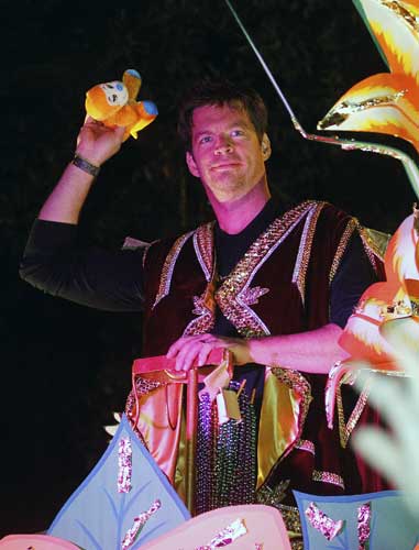 Harry Connick tosses throws while riding in the Mardi Gras parade in New Orleans, Monday, Feb. 20, 2012.