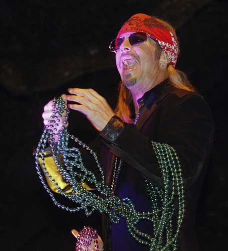 Entertainer Bret Michaels holds a handful of beads while riding in the Mardi Gras parade in New Orleans, Monday, Feb. 20, 2012.