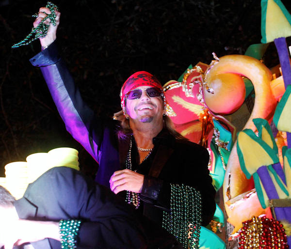 Entertainer Bret Michaels holds a handful of beads while riding in the Mardi Gras parade in New Orleans, Monday, Feb. 20, 2012. (AP Photo/Bill Haber)