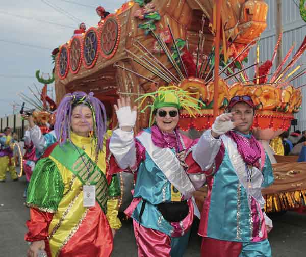Riders in the Mardi Gras parade make their way to their float in the staging area of the parade in New Orleans, Monday, Feb. 20, 2012.