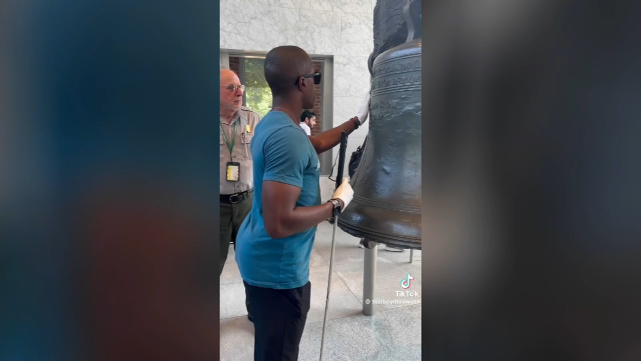 National Park Service Ranger helps blind man touch the Liberty Bell