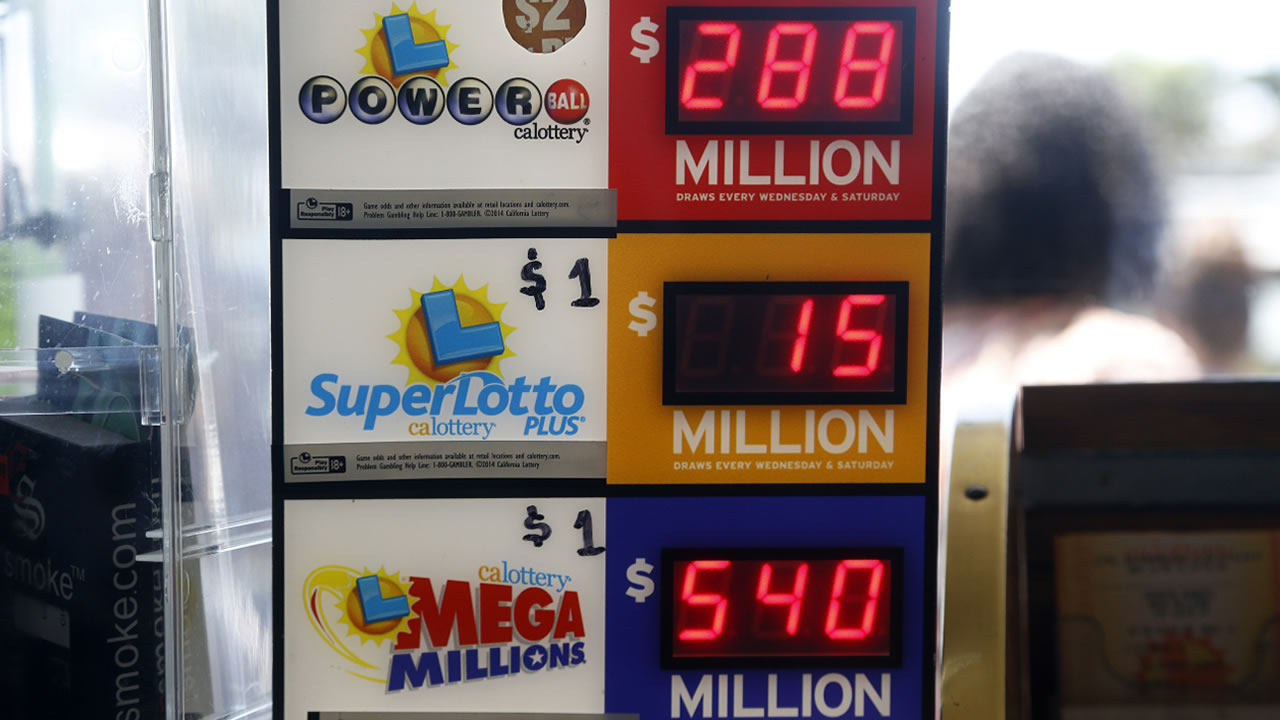 An electronic sign at Bluebird Liquors in Hawthorne, Calif., displays lottery jackpots Friday, July 8, 2016. The Mega Millions jackpot for Friday's drawing has soared to over $500 million. 